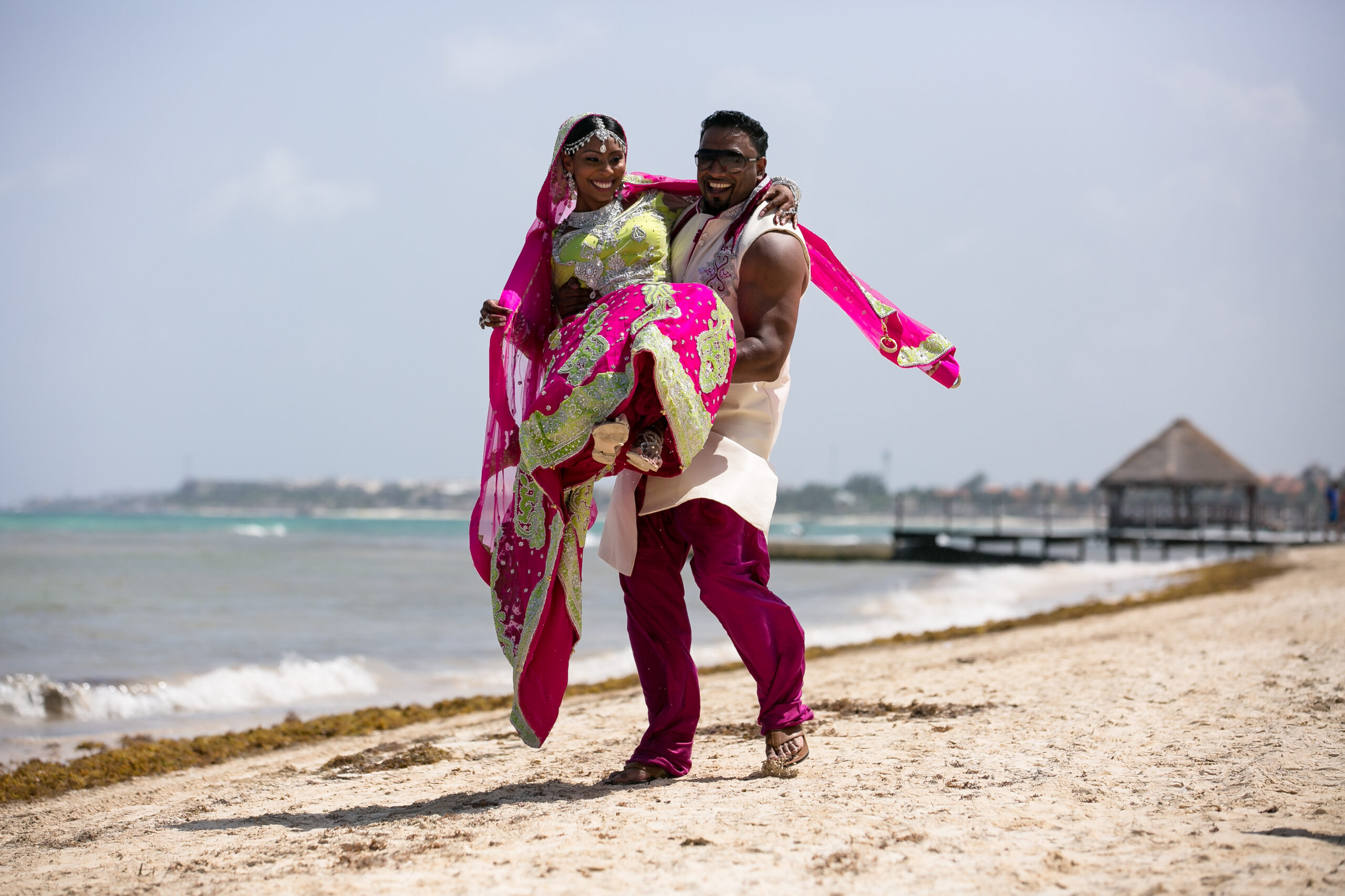 Hindu couple embrace on Cancun Beach