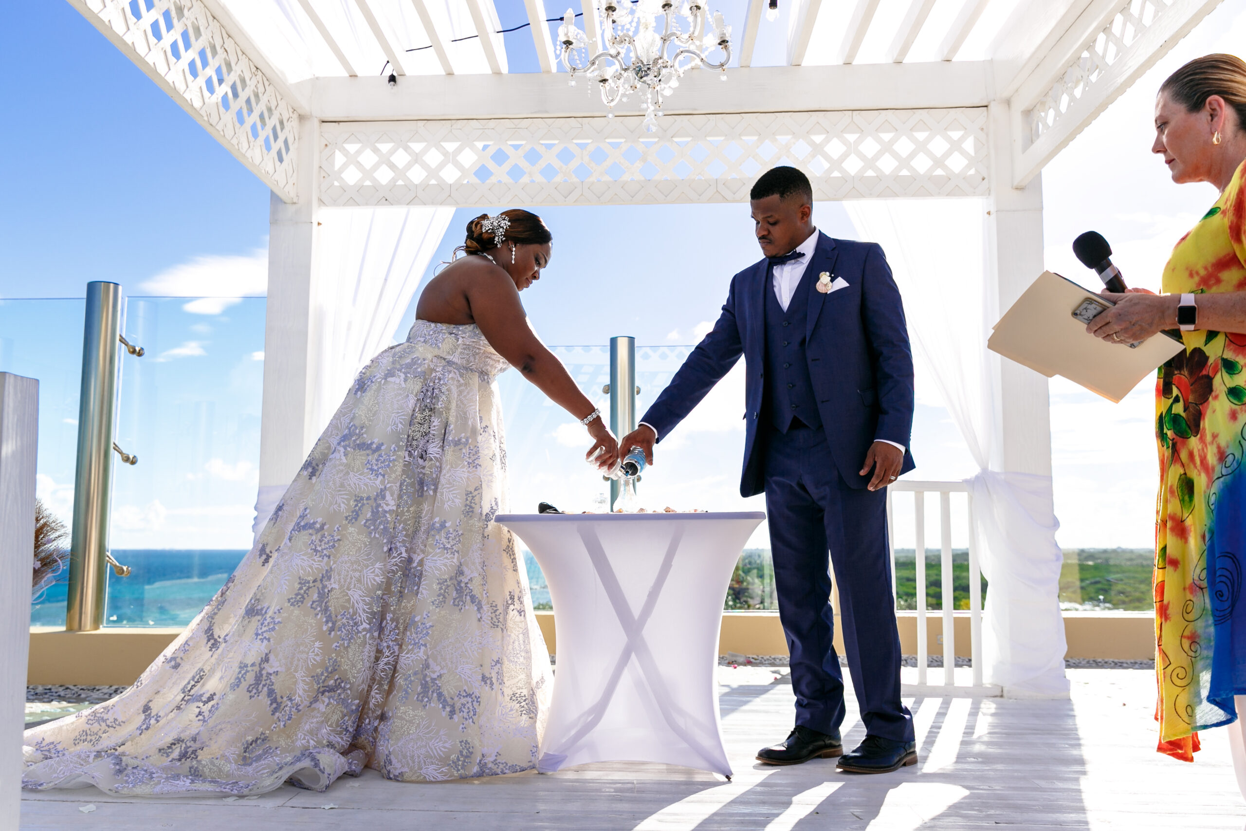 Wedding couple pour sand at their ceremony