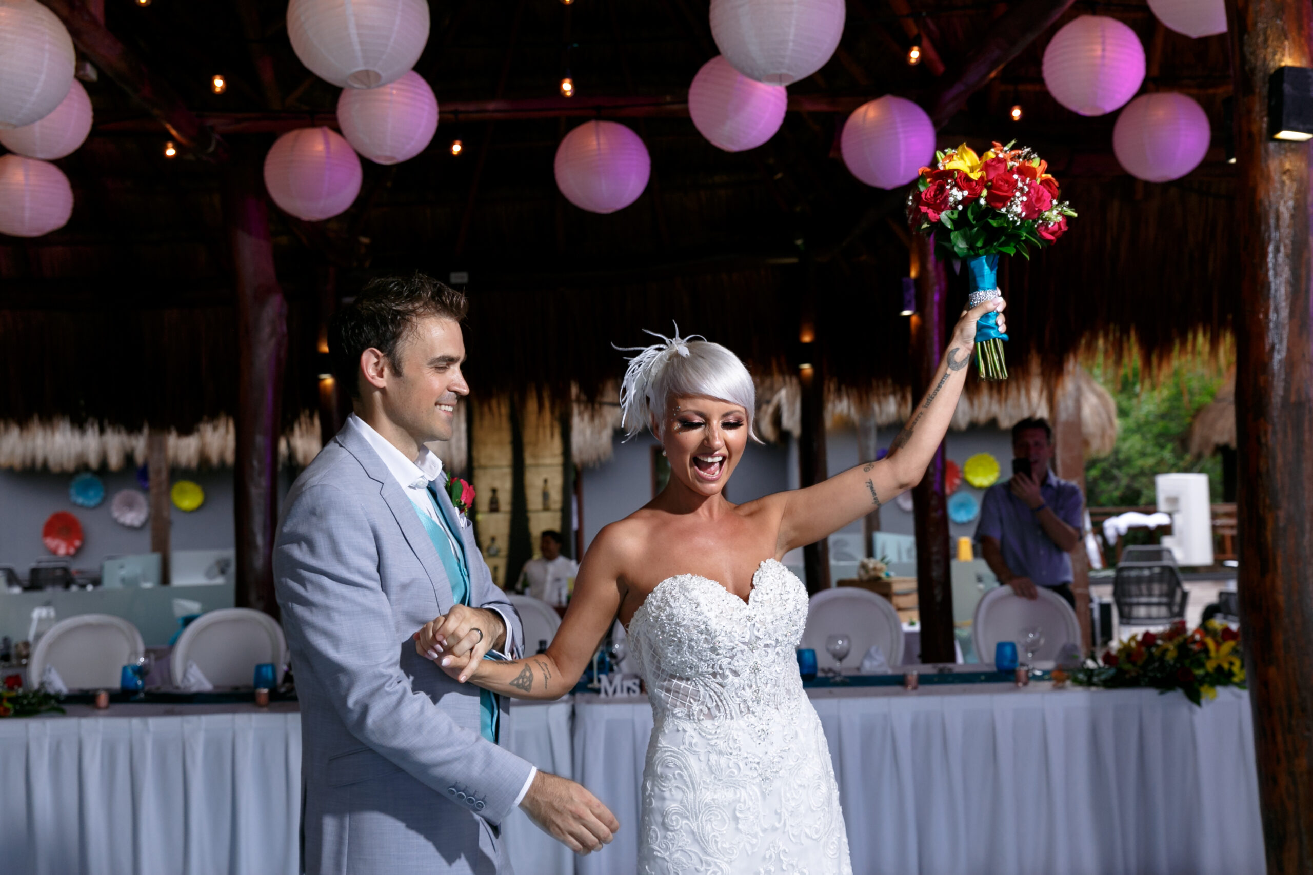 Newlyweds enter reception with arms held high