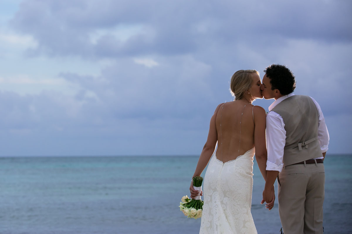 Dreams Jade Wedding couple embrace by the azure blue ocean