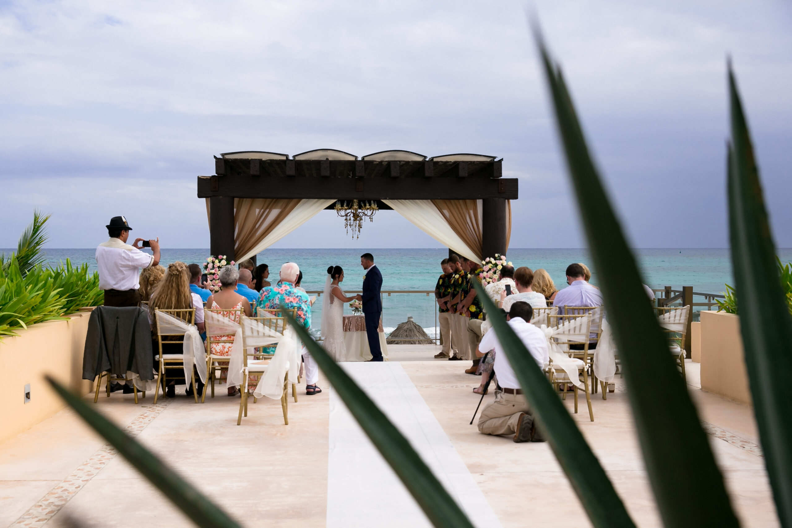 Wedding couple marry under wooden pavilion roof