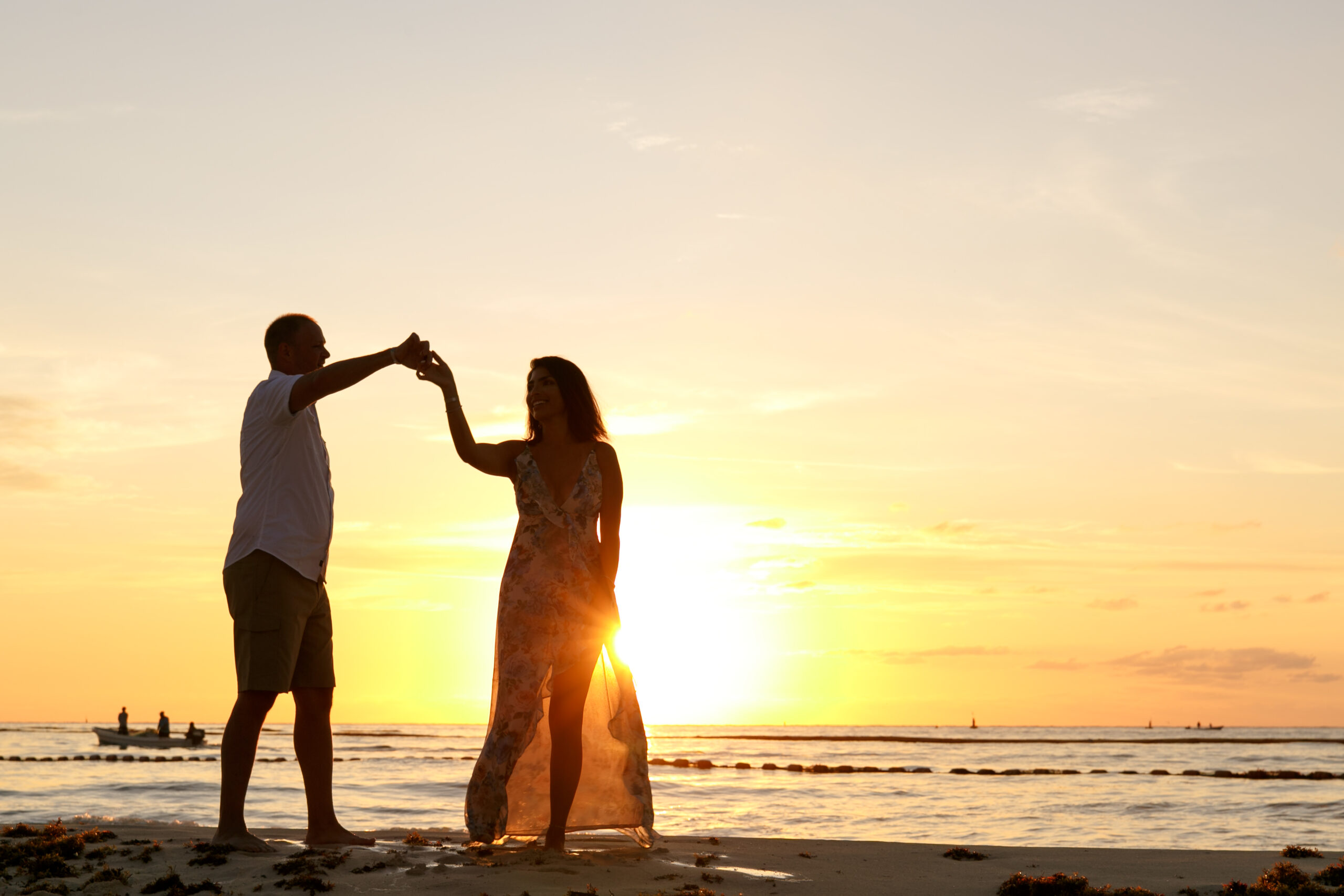 Dancing couple silhouetted against the spectacular sunrise