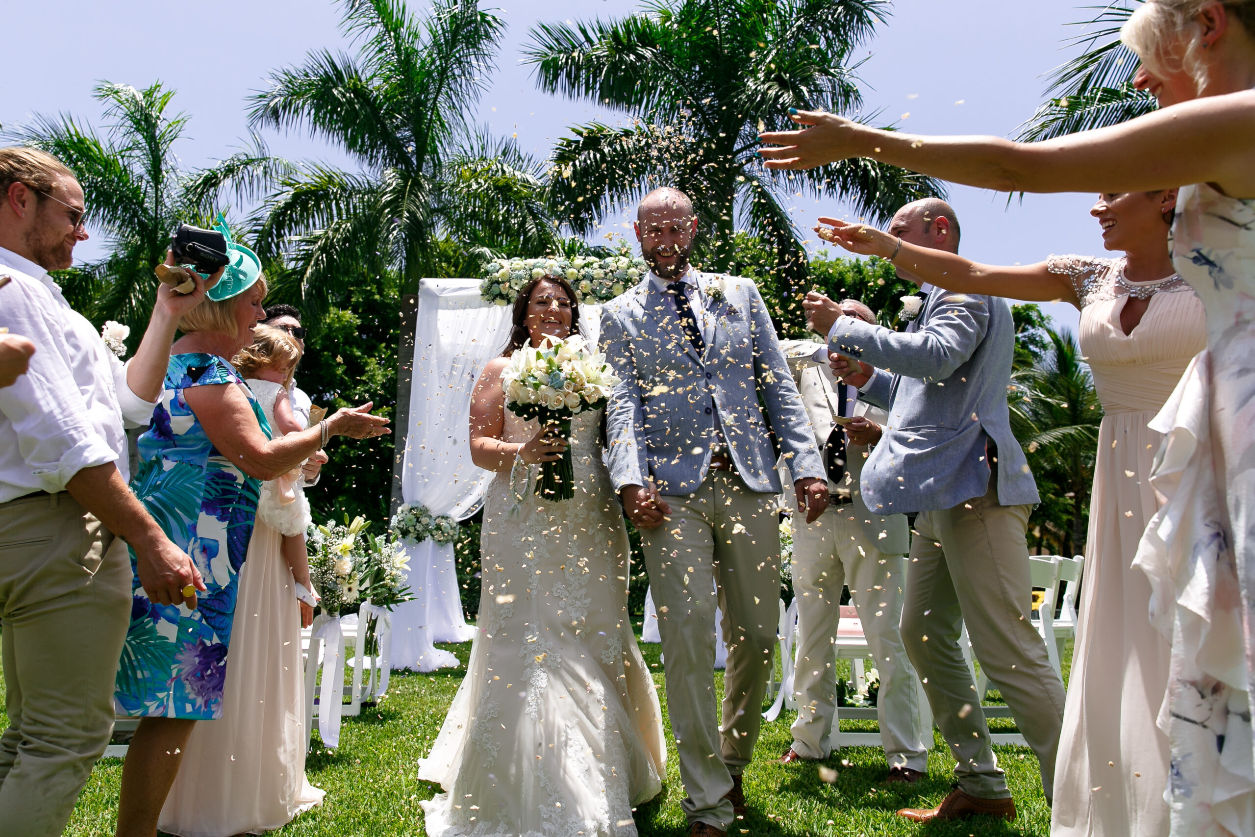 Newlyweds walk gauntlet of floral petals thrown by their happy guests