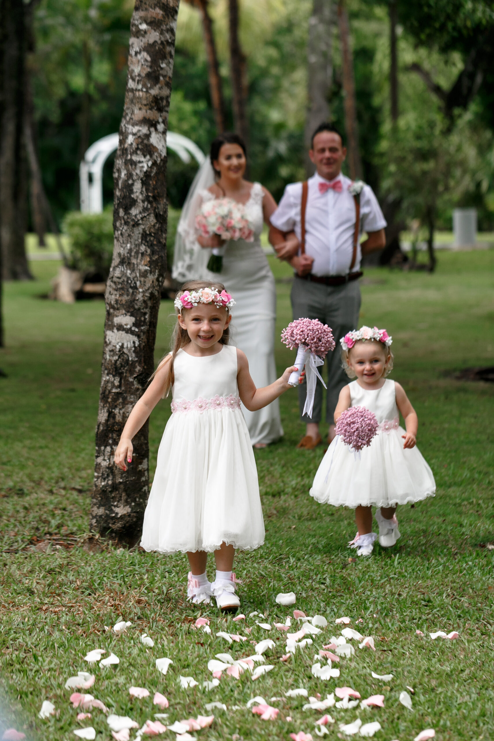 Adorable flower girls lead bride down the path to meet her groom