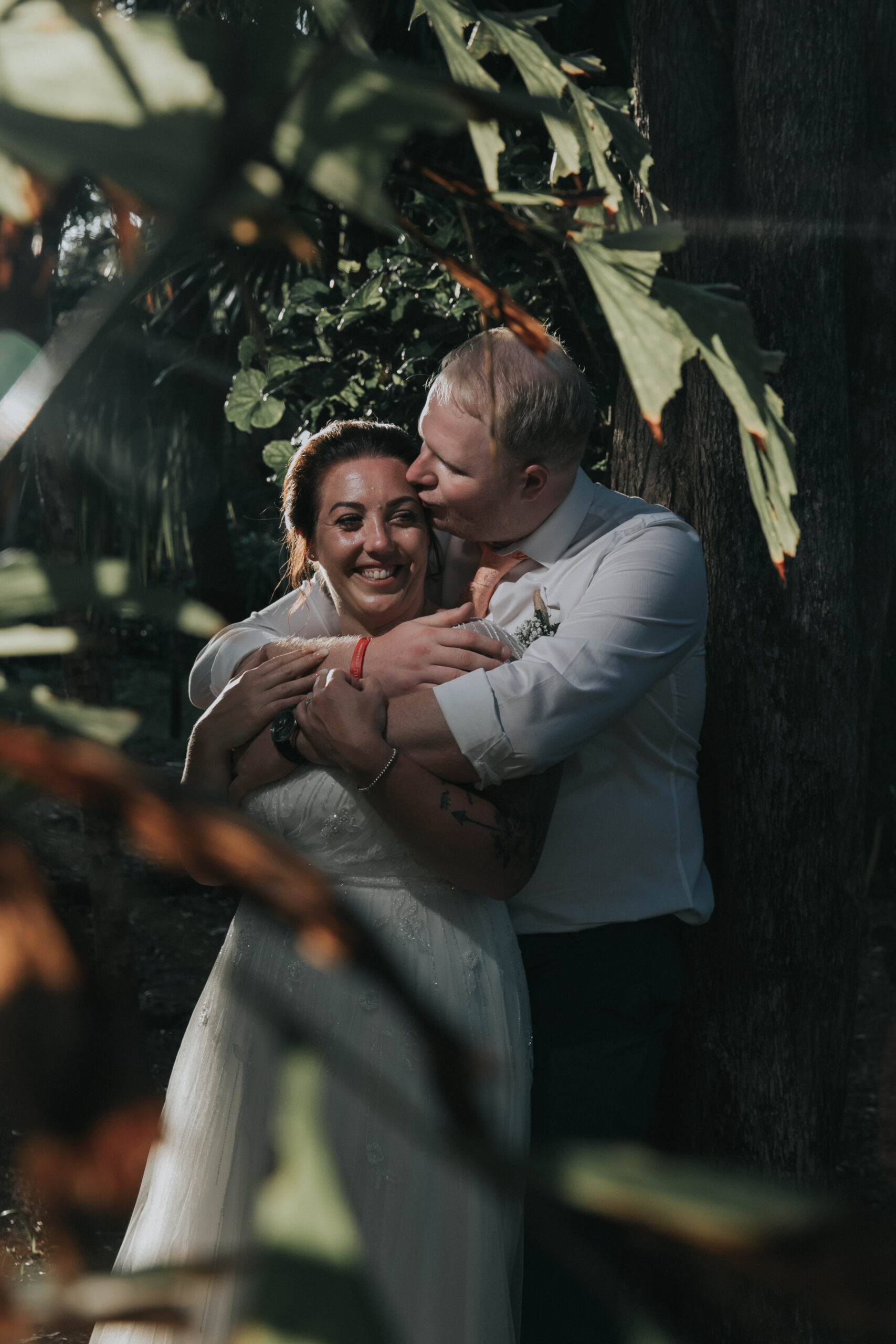 Newlywed husband cradles his bride in an intimate embrace