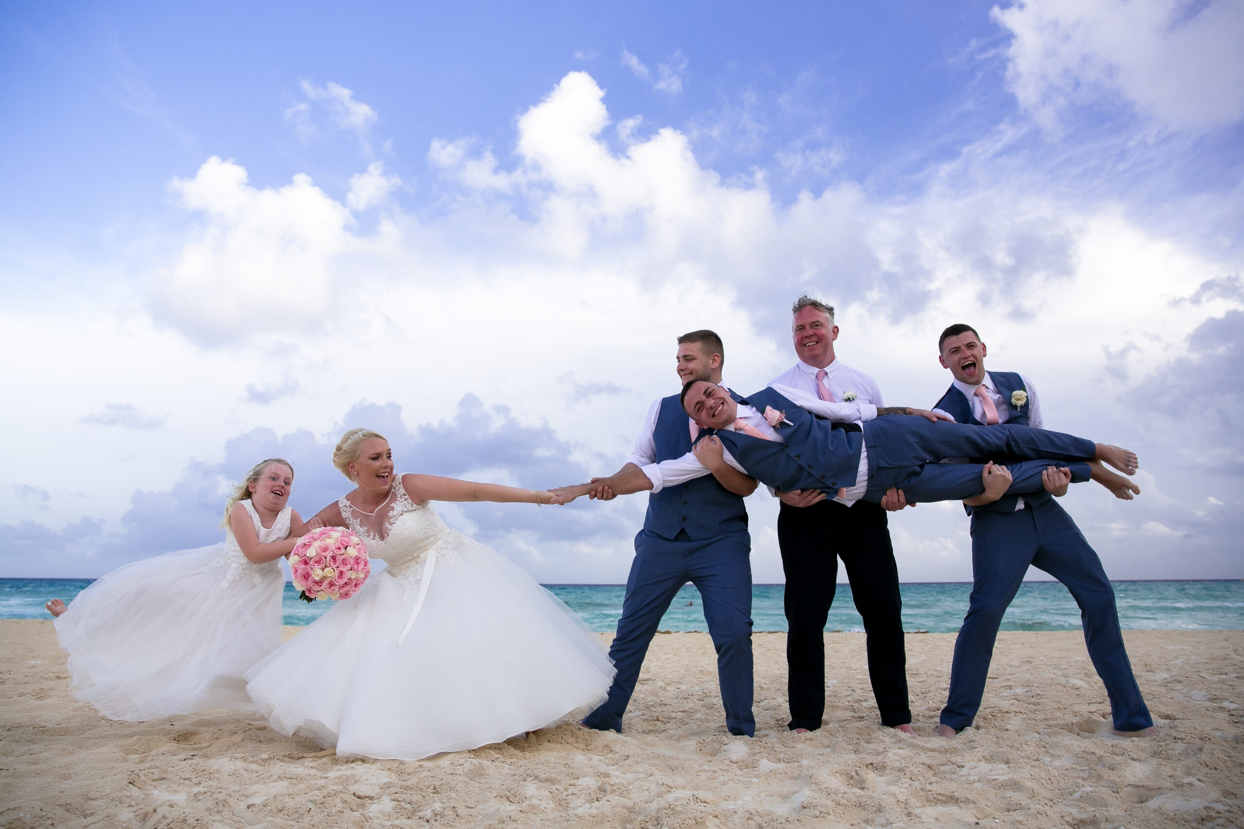 Pulling bride and groom apart on Rui Yucatan beach