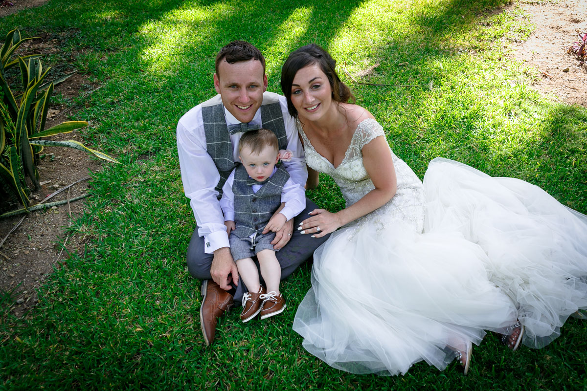 Newlyweds cradle their "mini-me" son in matching outfit