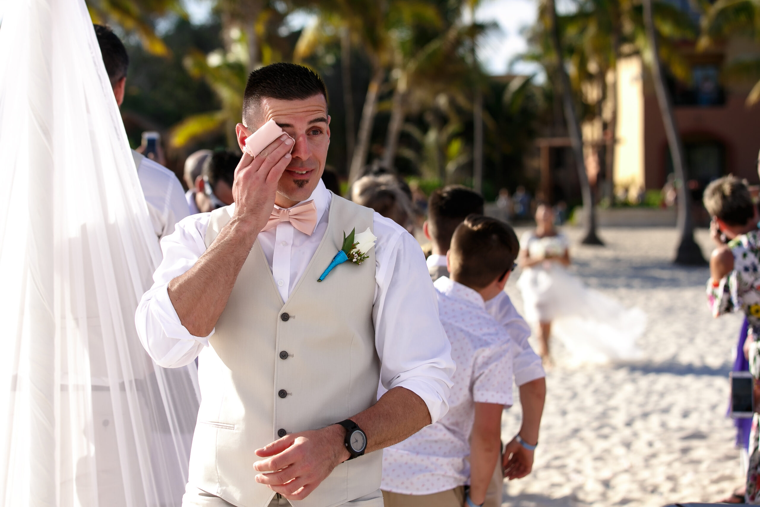 Emotional groom sees his beautiful bride coming down the aisle