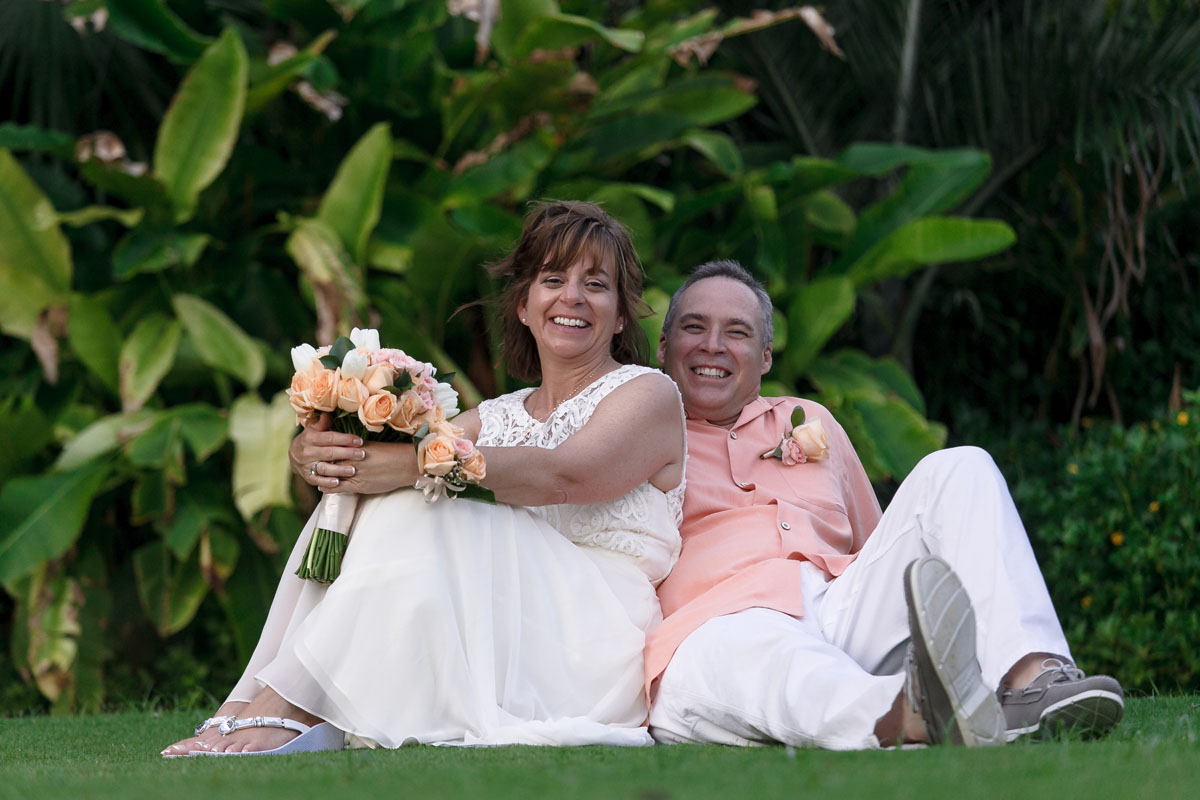 Happy smiling couple sit on grass