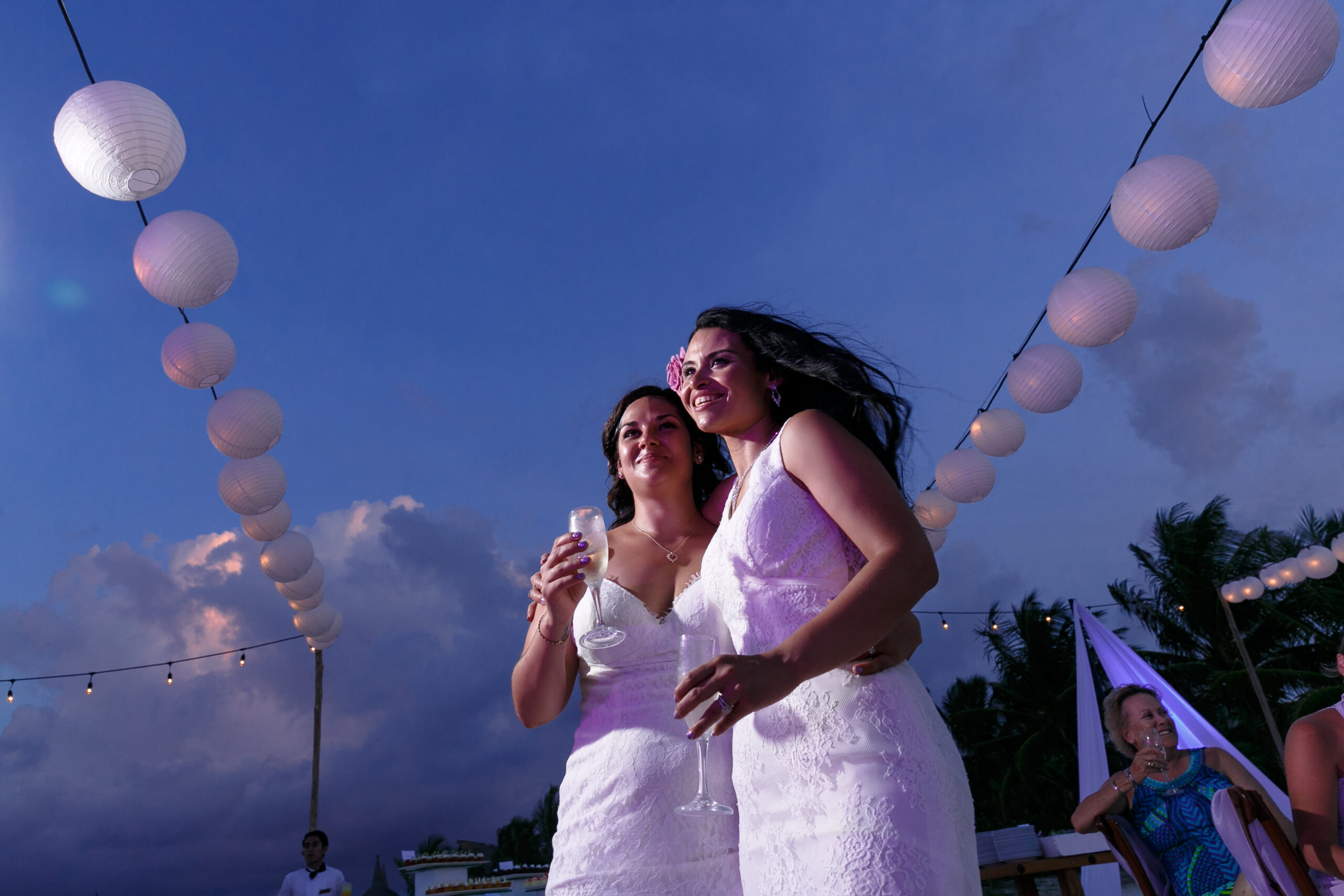 Same sex wedding brides toast each other at their Secrets Maroma wedding