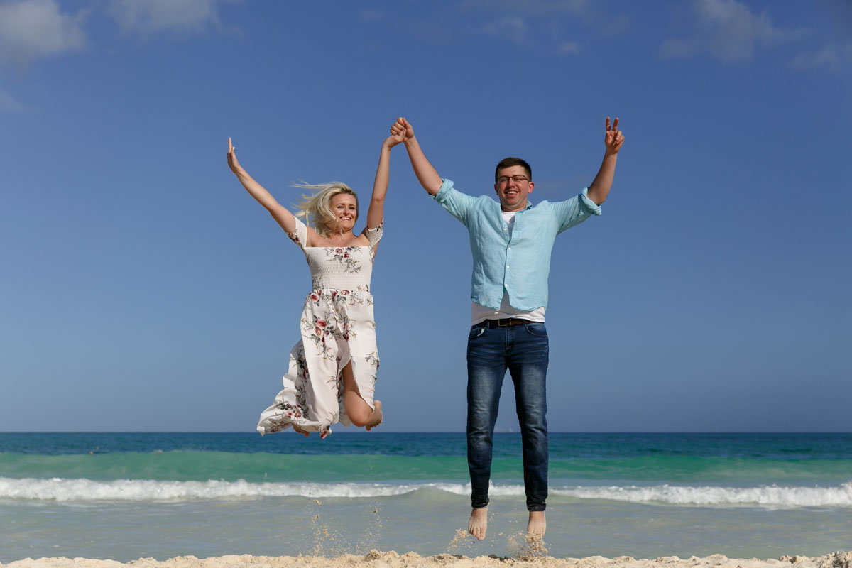 Newly engaged couple jump for joy