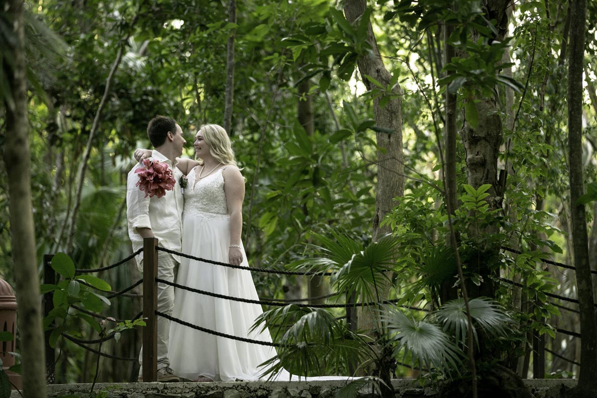 Bride drapes her arm around her husband's neck