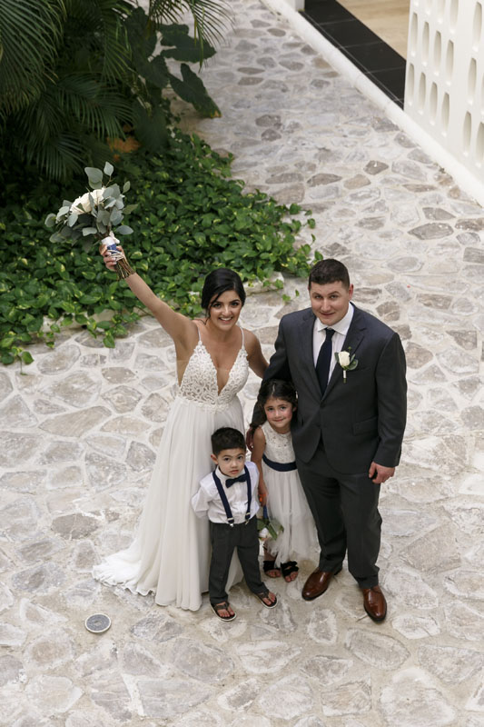 Newlyweds with their two kids cheer