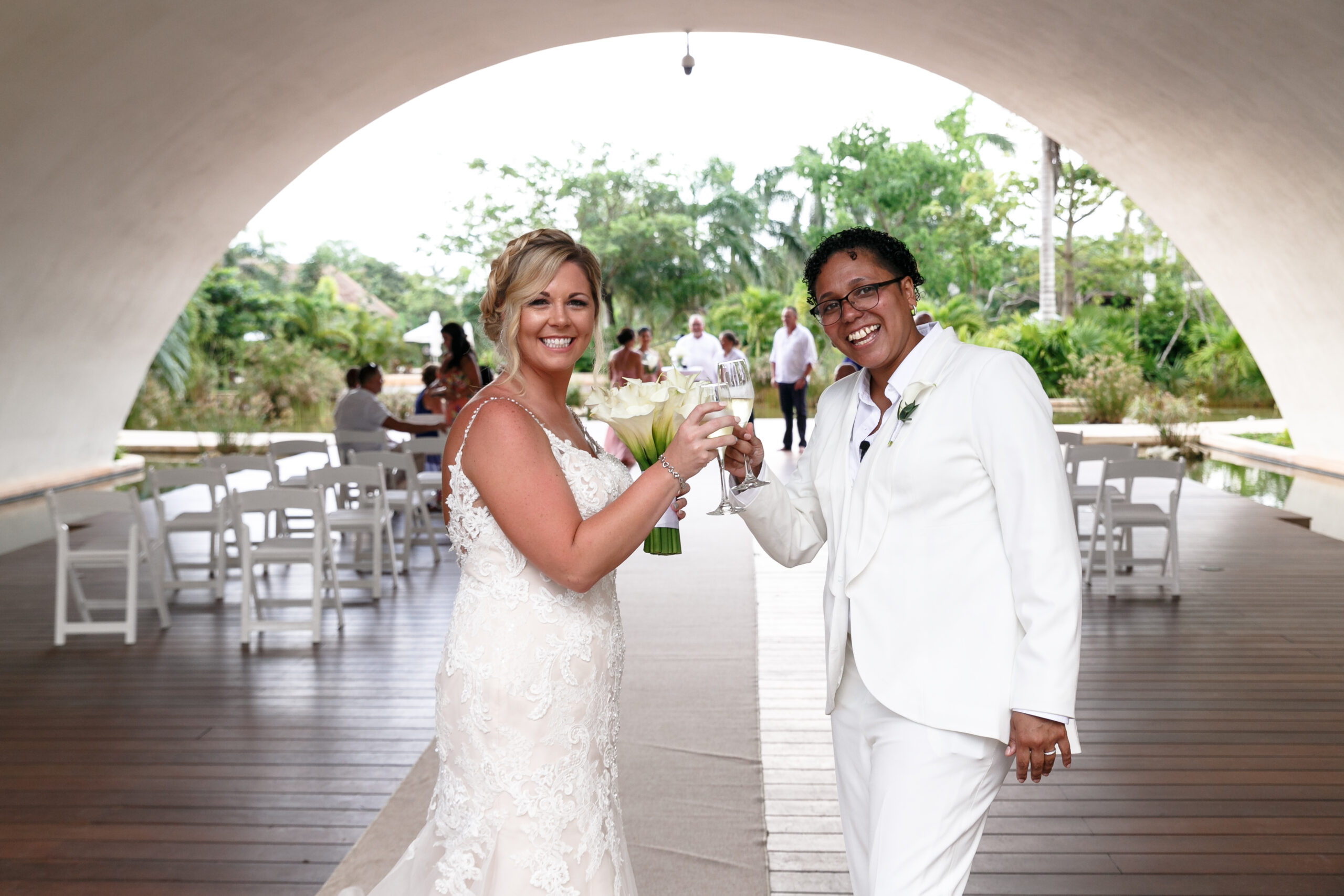 Same sex newlyweds toast each other after ceremony