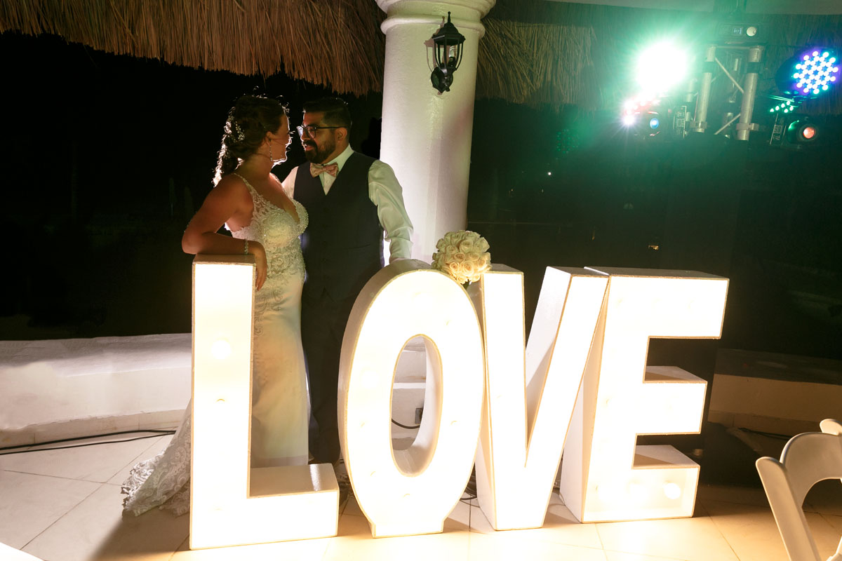 Newlyweds pose behind LOVE sign