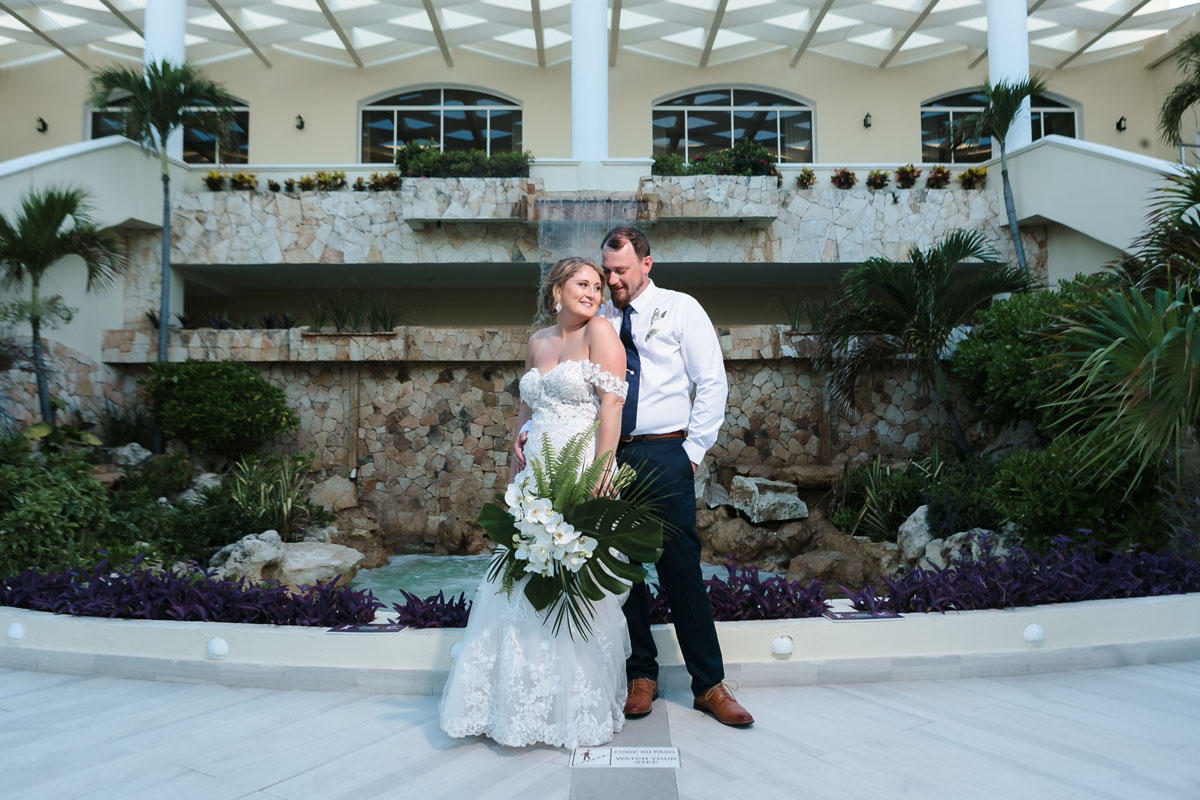 Newlyweds snuggle in front of El Dorado Royale fountain