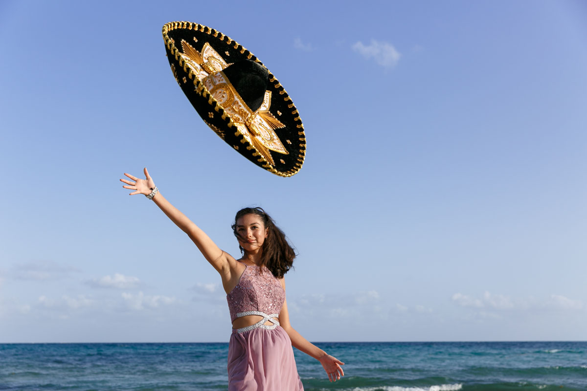 Alessandra tosses her sombrero in celebration of her Quinceanera