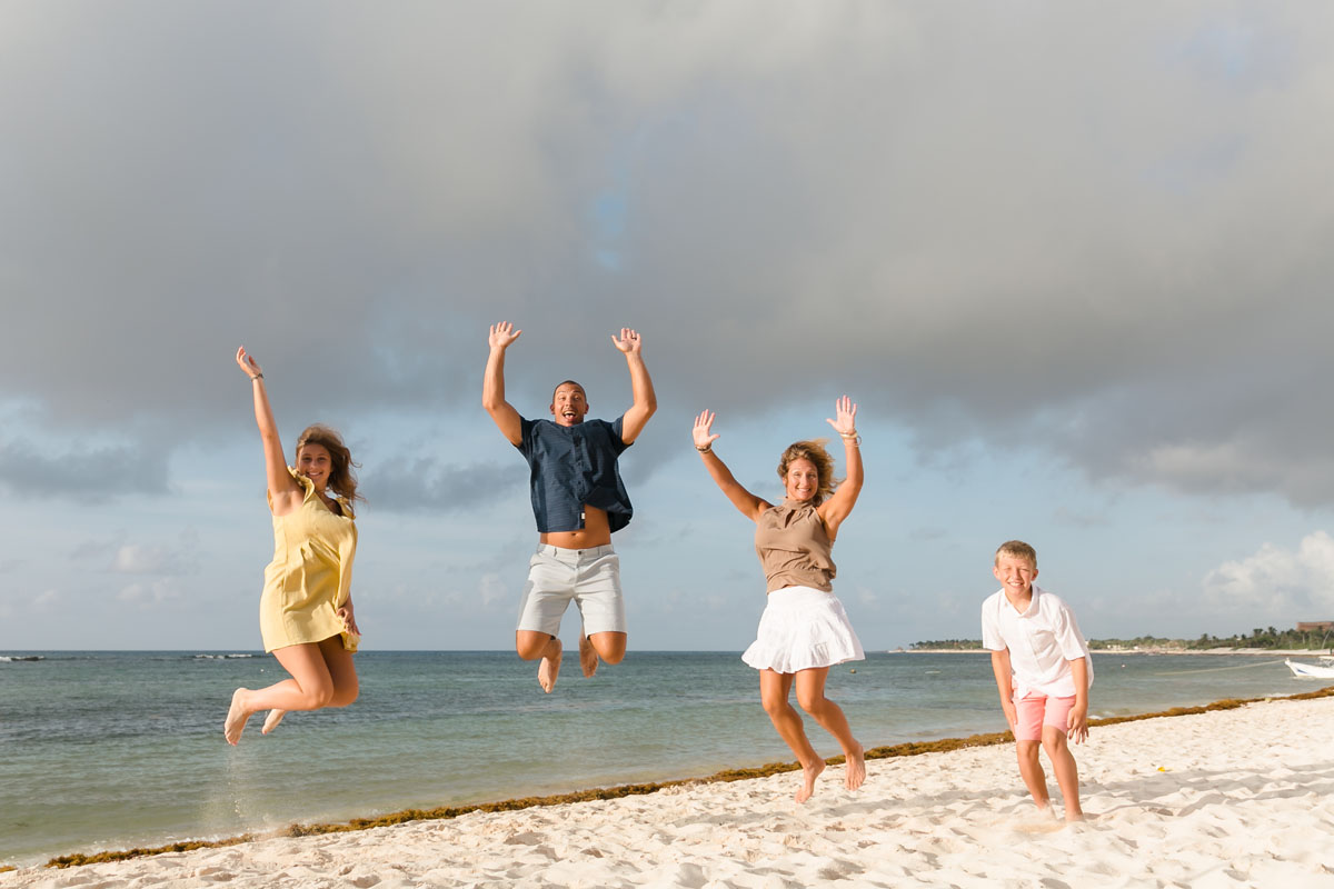 Family jumping for joy together on the beach