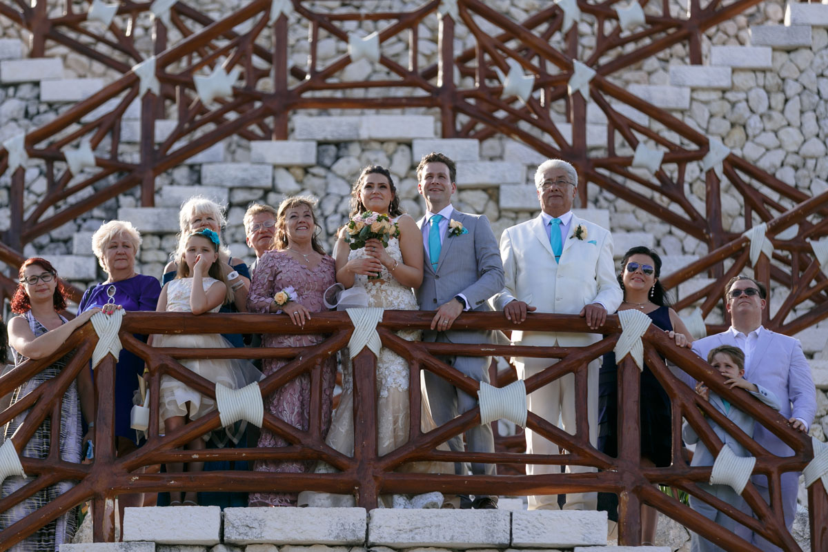 Friends surround newlyweds on chapel stairs