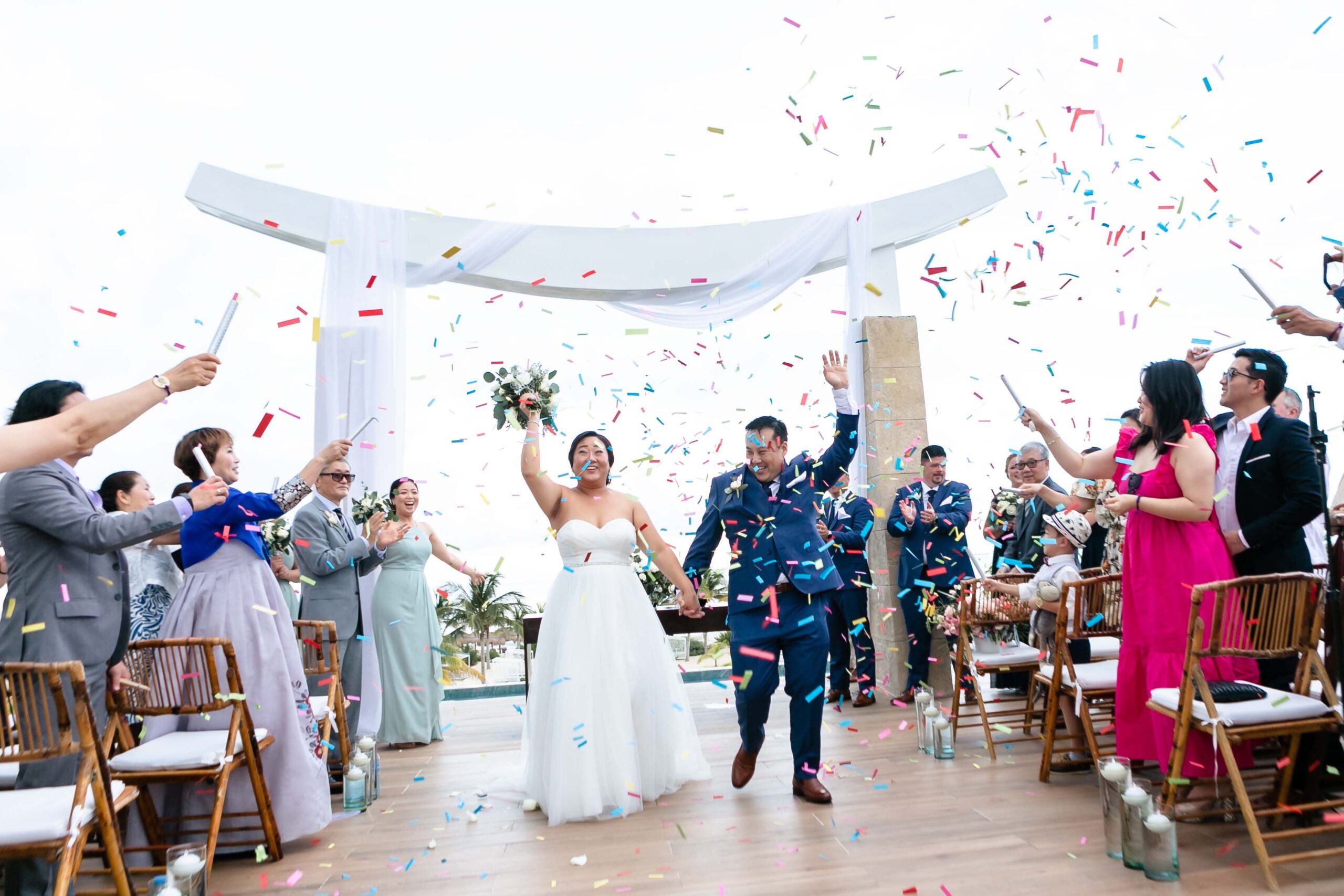 Newlyweds walk out under hail of colorful confetti