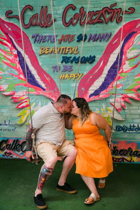 Romantic couple kisses on a swing on Playa's 5th Ave.