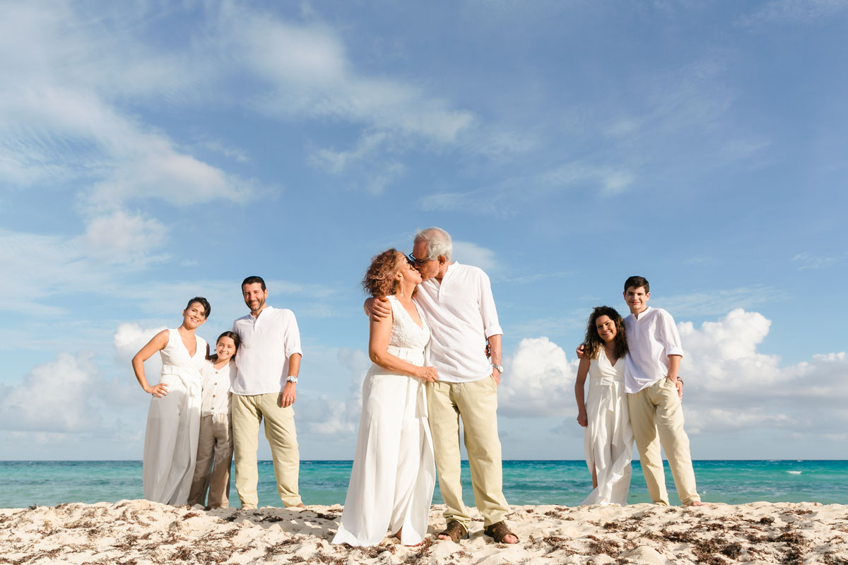 Family watches Grandparents kiss on beach