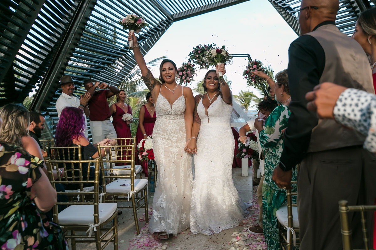 Newlyweds cheer walking out after their ceremony