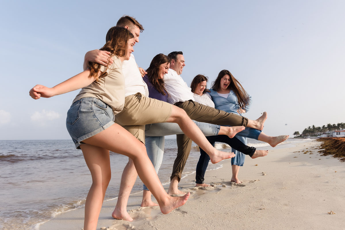 Family rocking a leg kick on the beach