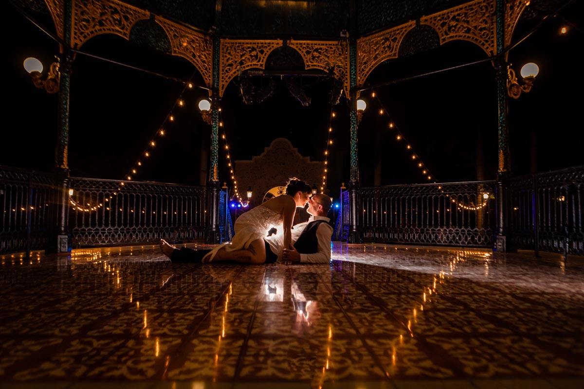 Newlyweds kiss on floor of golden pagoda