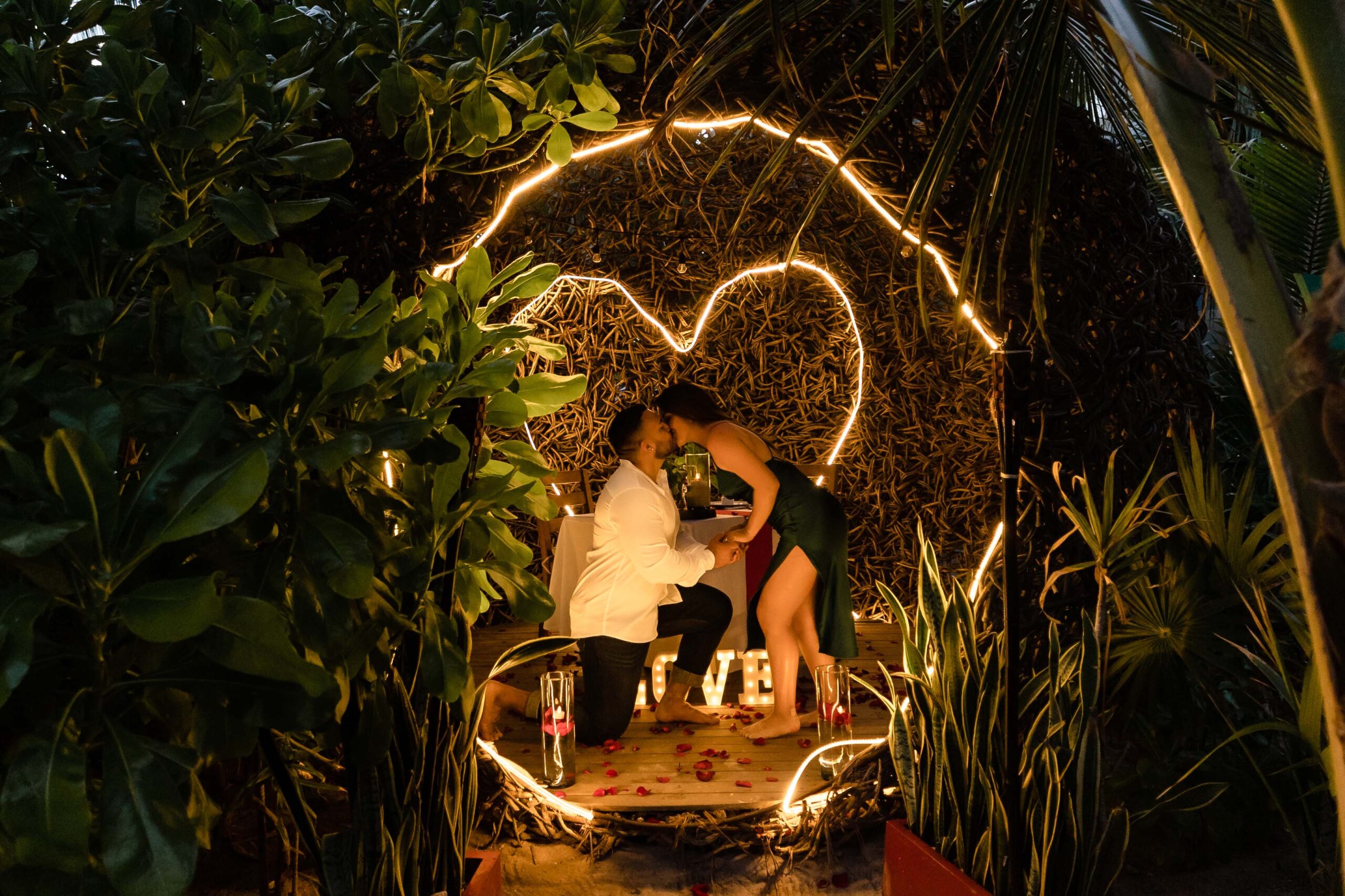 Girlfriend bends to kiss her proposing boyfriend