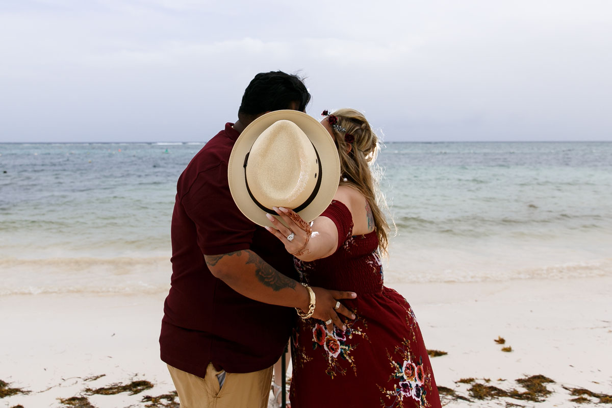 MomHoldingHatBlockingKiss