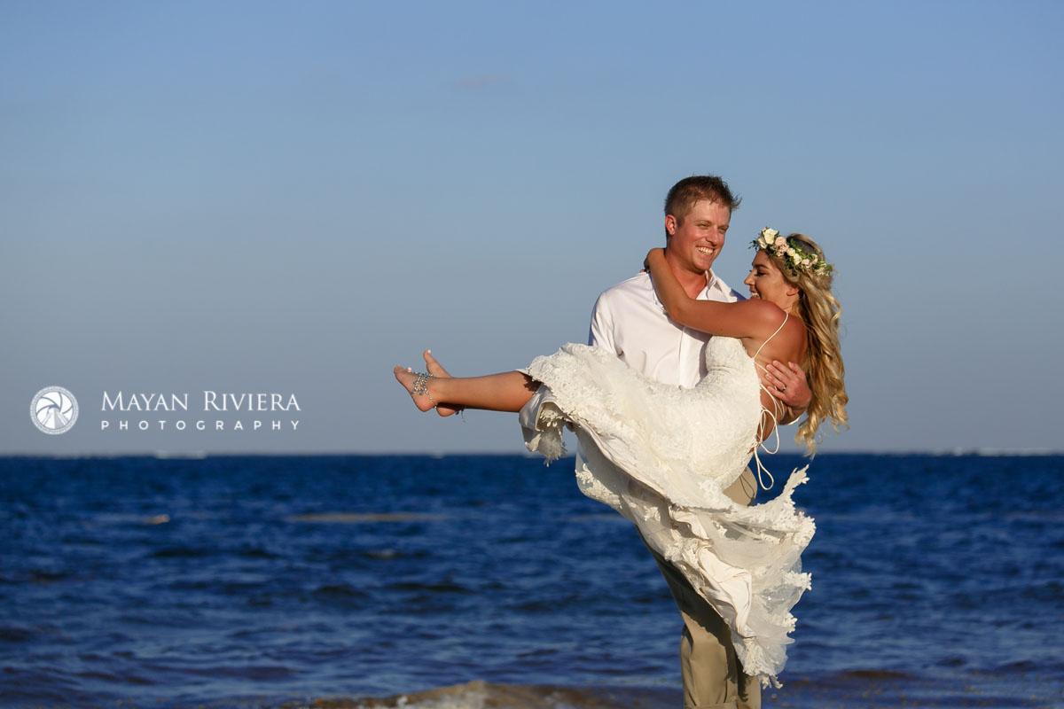 GroomTwirlsBrideInHisArmsOnBeach