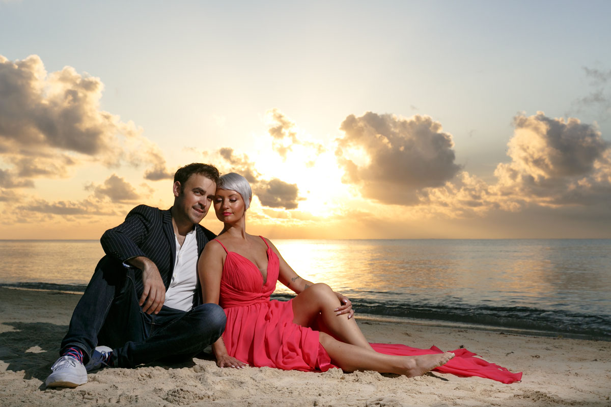 GitaAndAlanReclineOnBeachAtSunrise