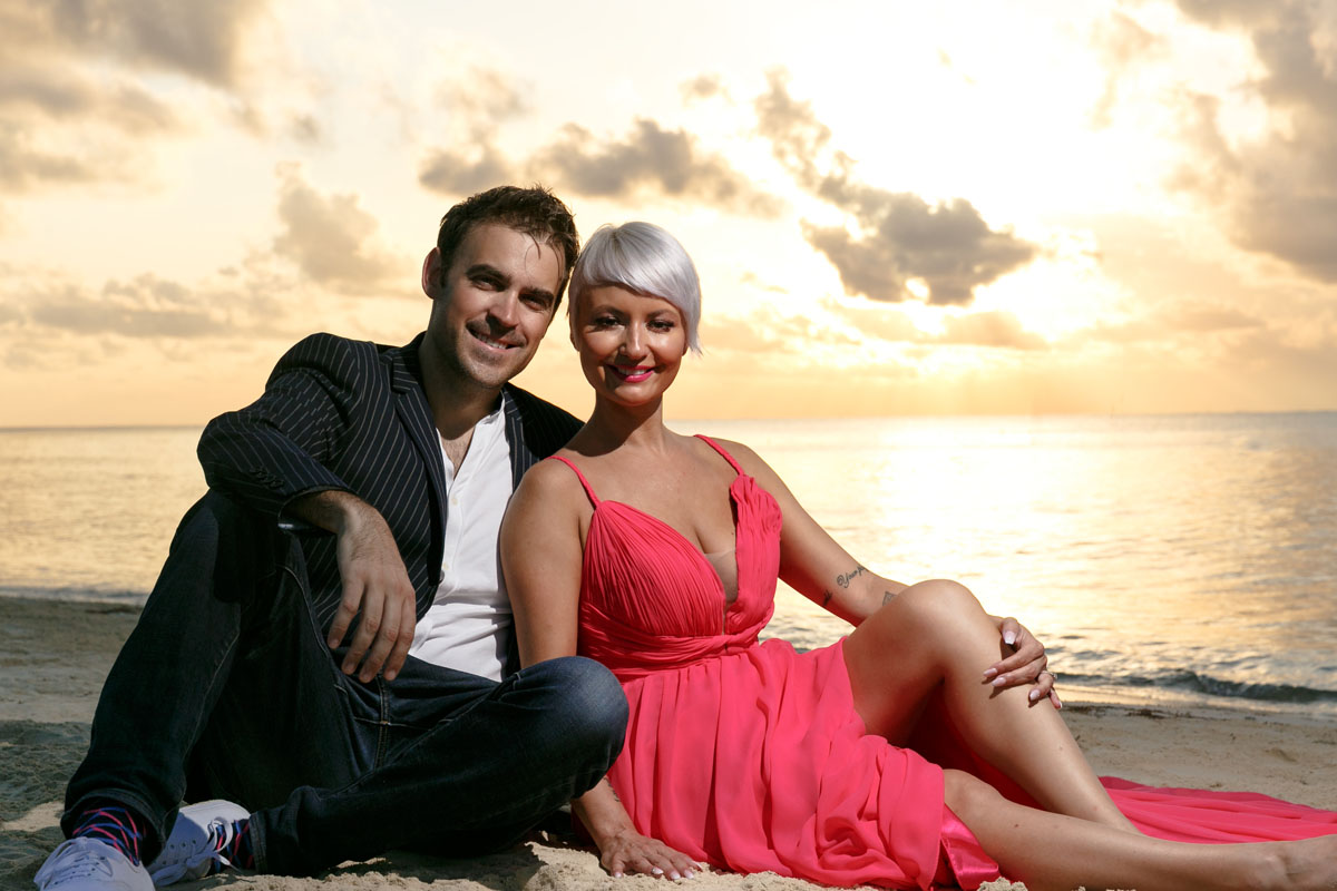 GitaAndAlanReclineOnBeachAtSunrise