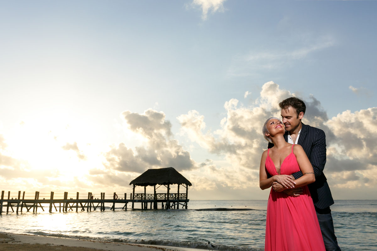 CoupleSnuggleOnBeachAtSunrise