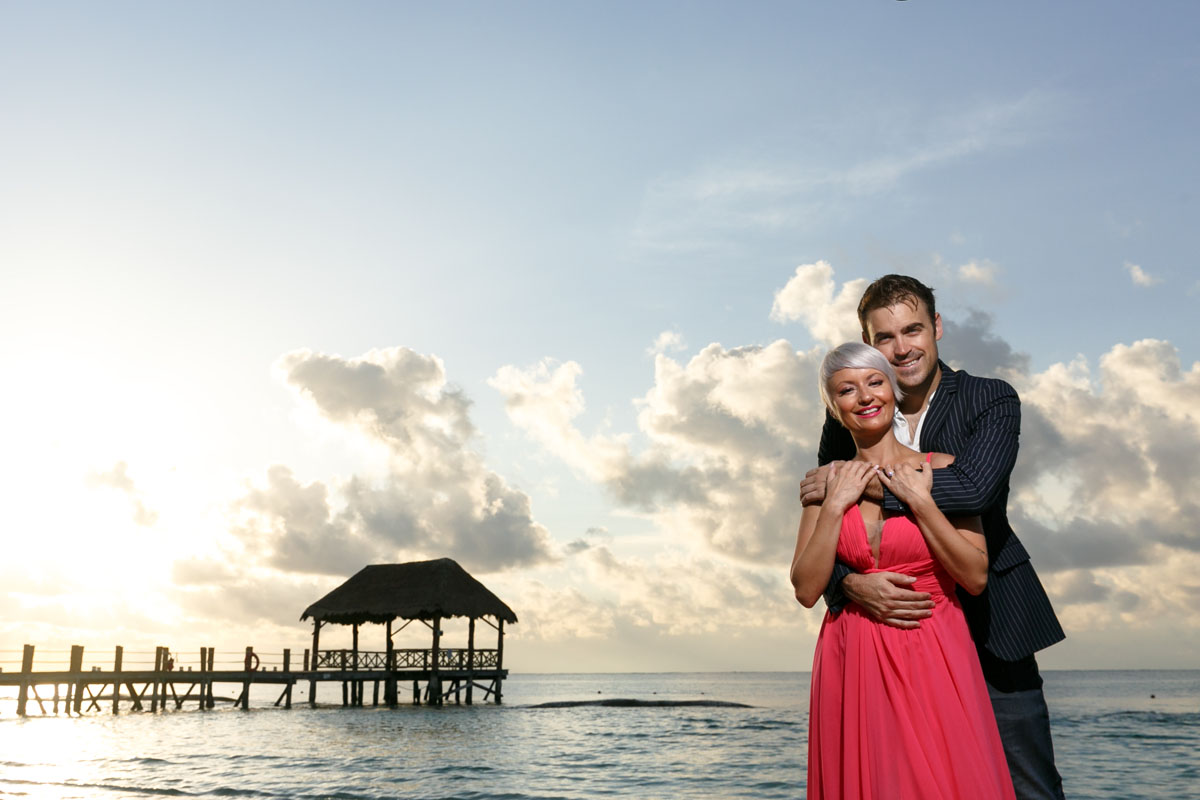 CoupleSnuggleOnBeachAtSunrise