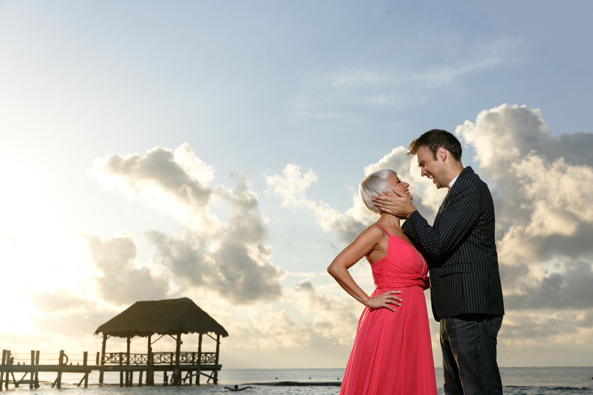 CoupleSnuggleOnBeachAtSunrise