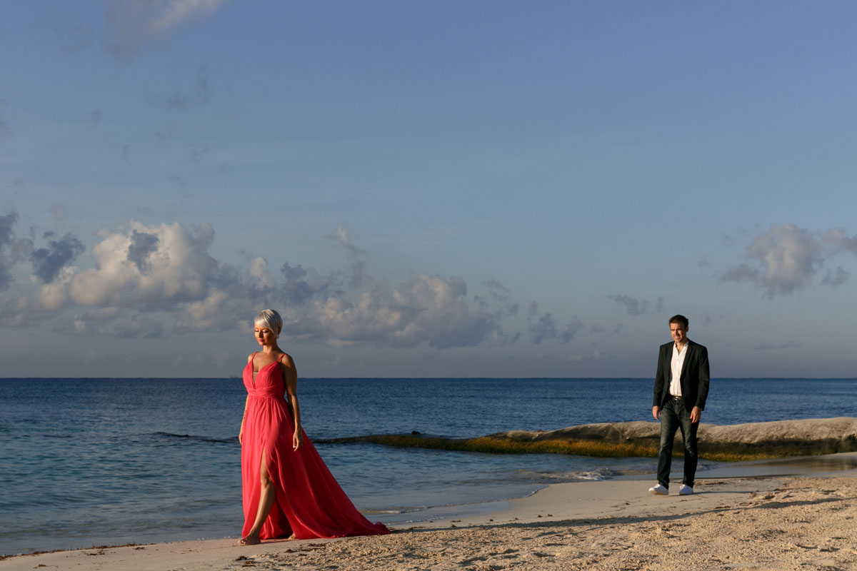 CoupleWalkingOnBeachAtSunrise