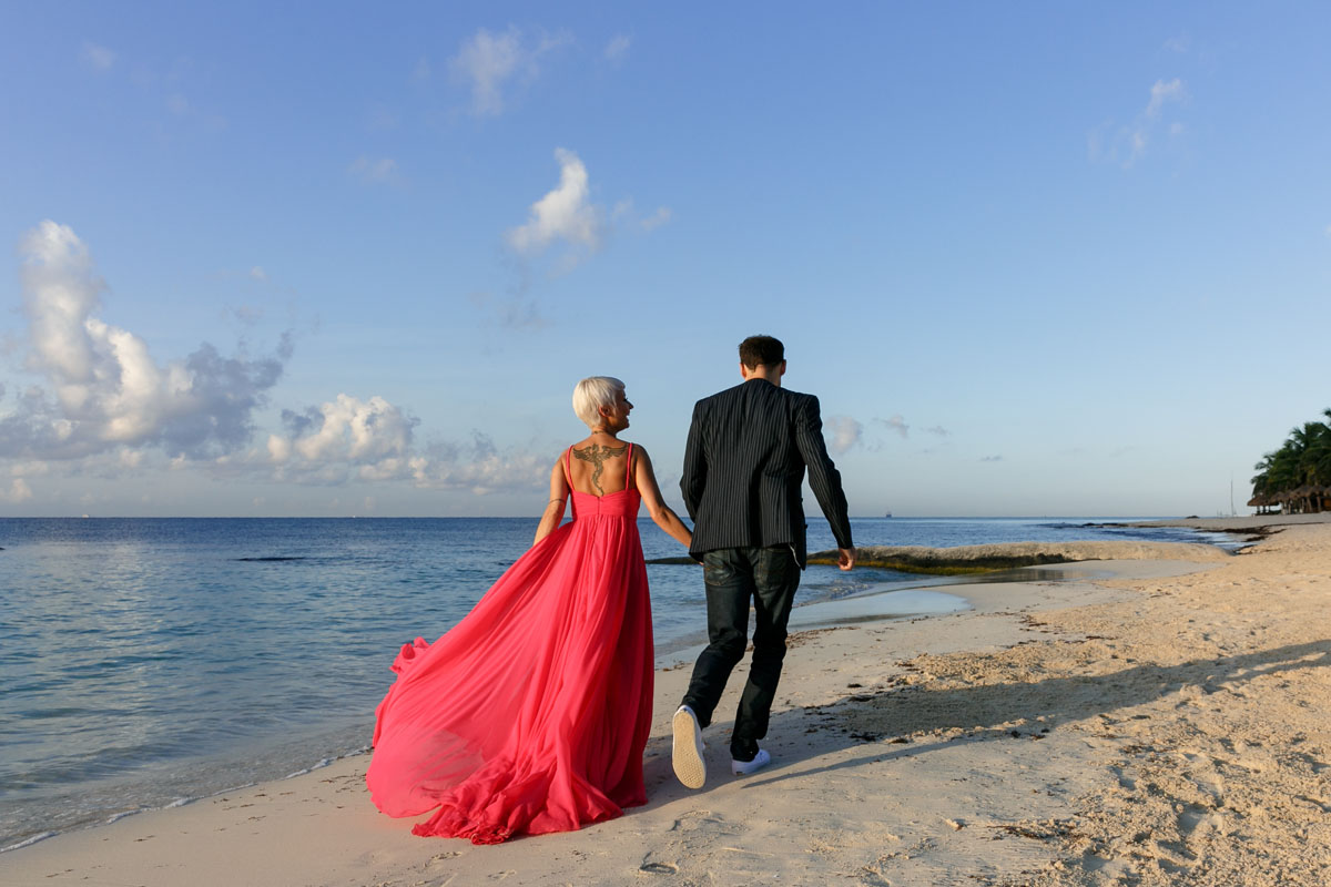CoupleStrollOnBeachAtSunrise