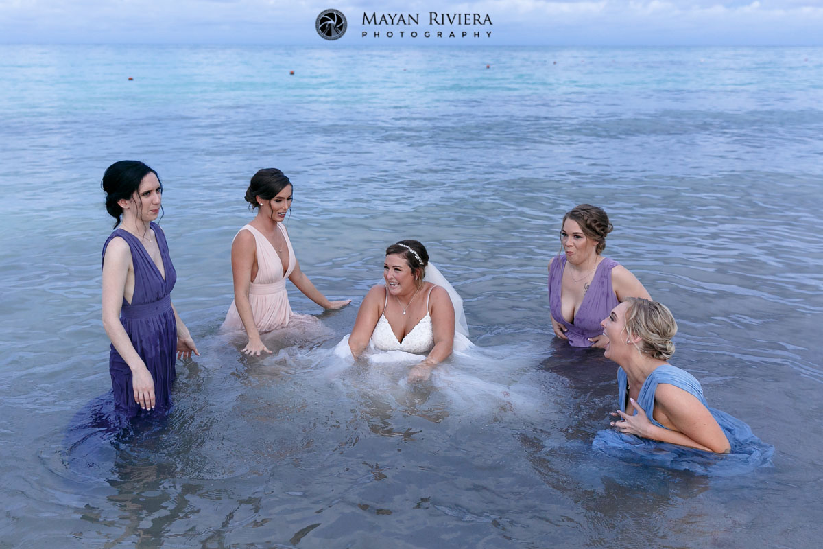 BrideAndBridesmaidsLaughInOcean