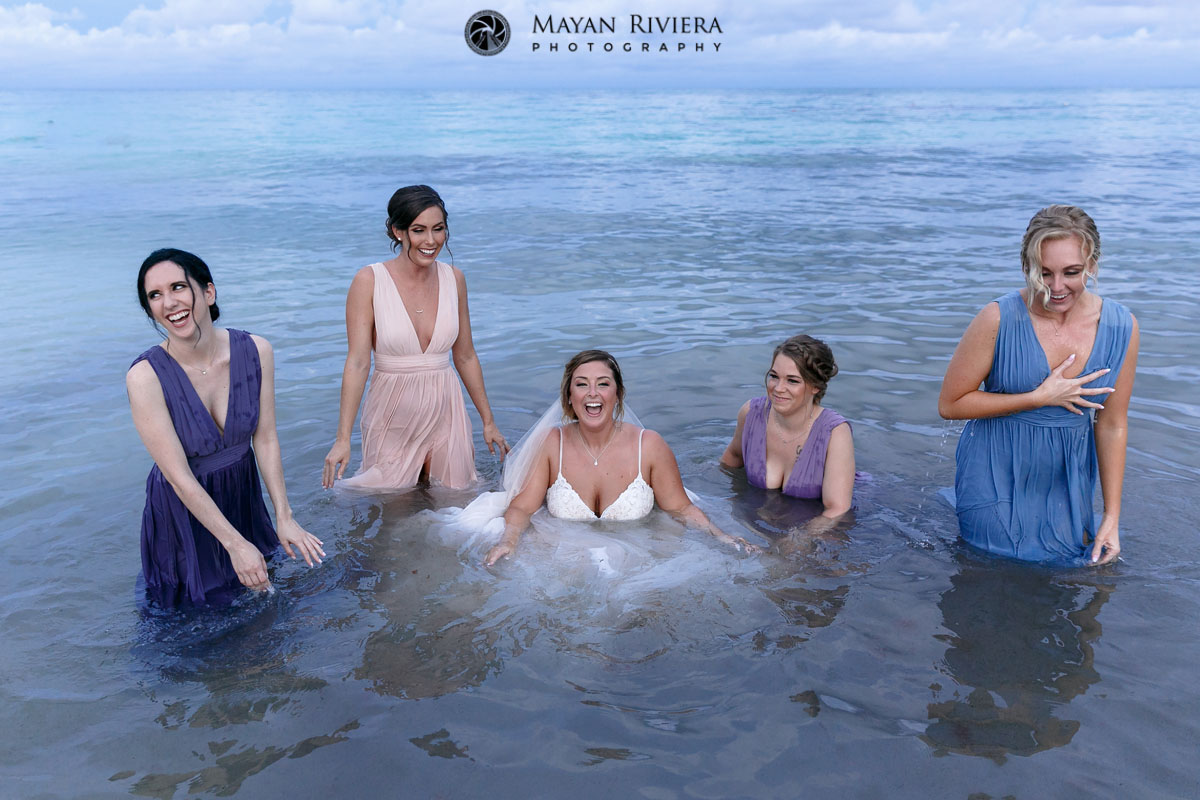 BrideAndBridesmaidsLaughInOcean