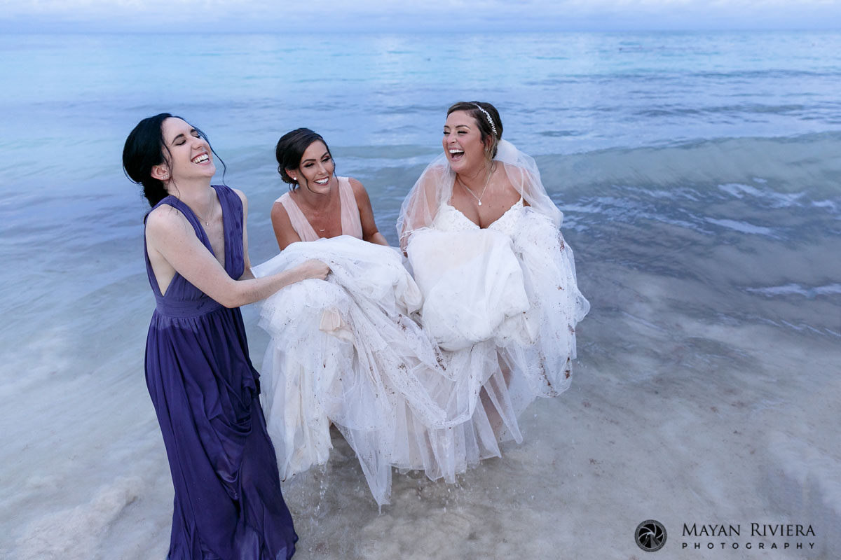 BrideAndBridesmaidsLaughInOcean