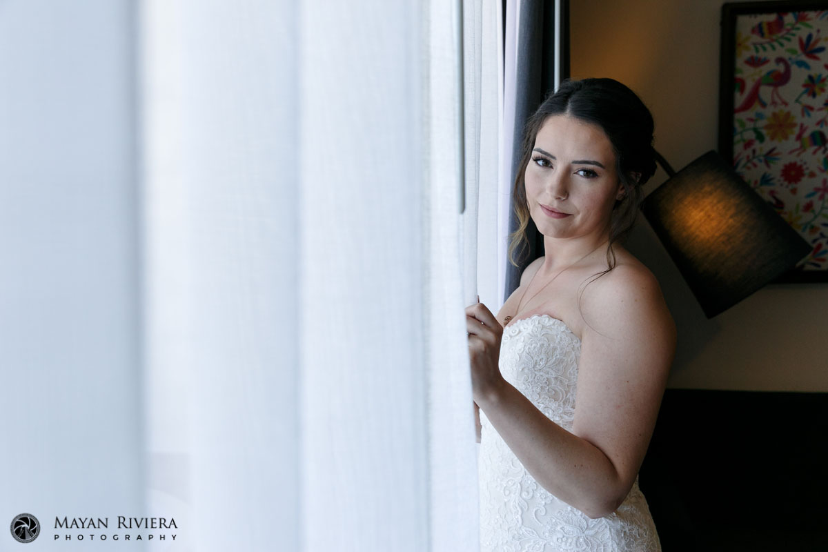 SmilingBrideStandsByWindow