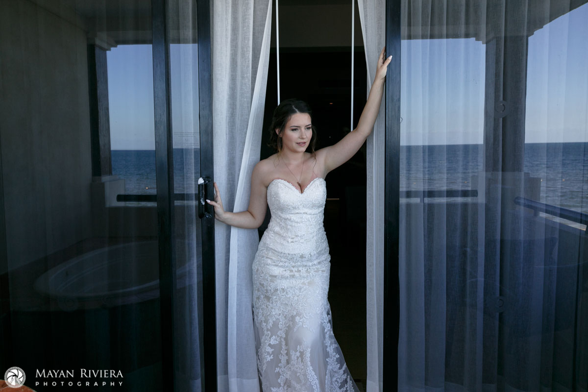 SmilingBrideStandsInWindow