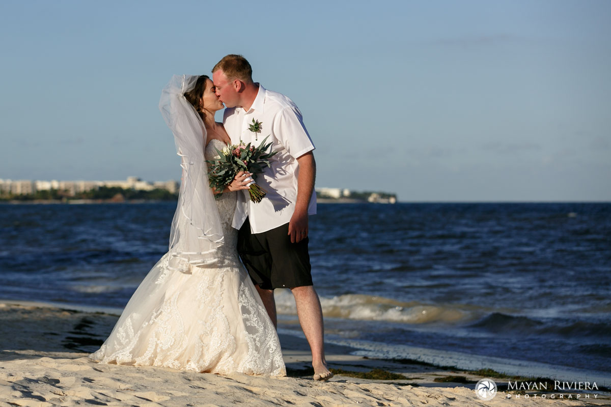 NewlywedsKissOnBeach