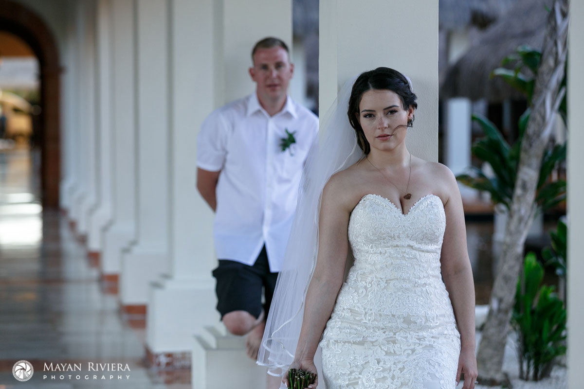 NewlywedsPoseInColumedHallway