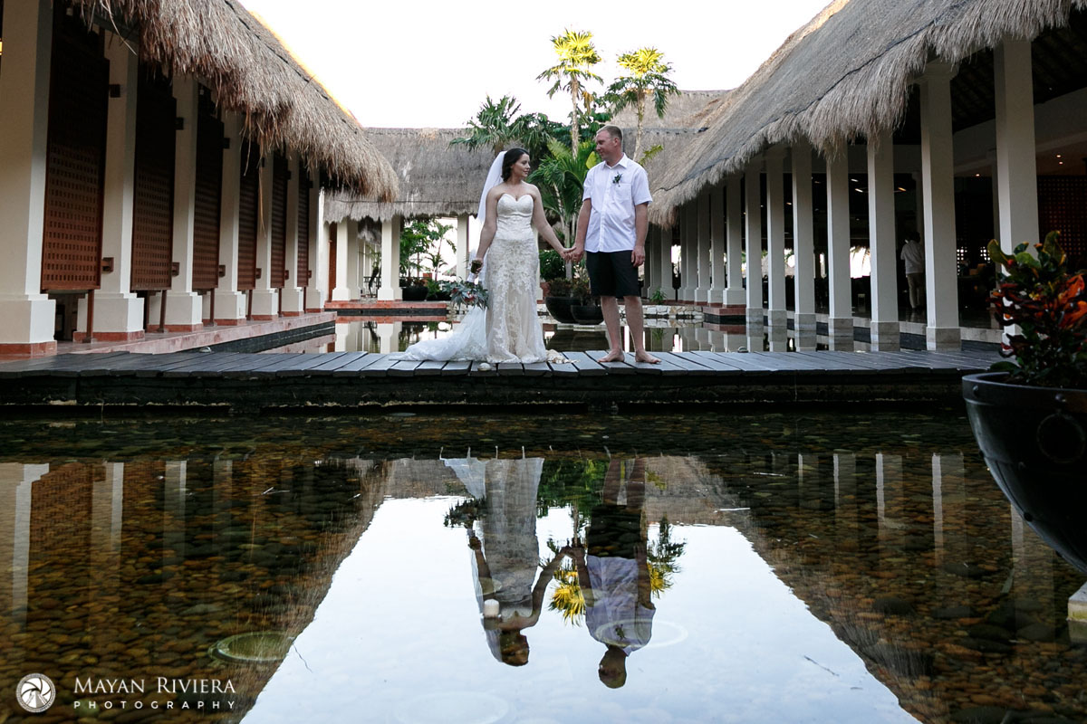 NewlywedsReflectionStandingOnPoolBridge