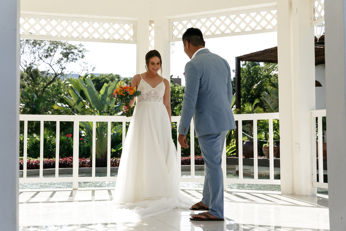 Groom admires his beautiful bride in her gown