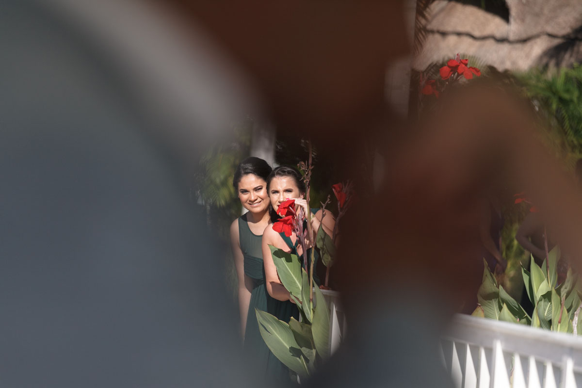 BridesmaidsSneakPeakGroomKissingBridesHand