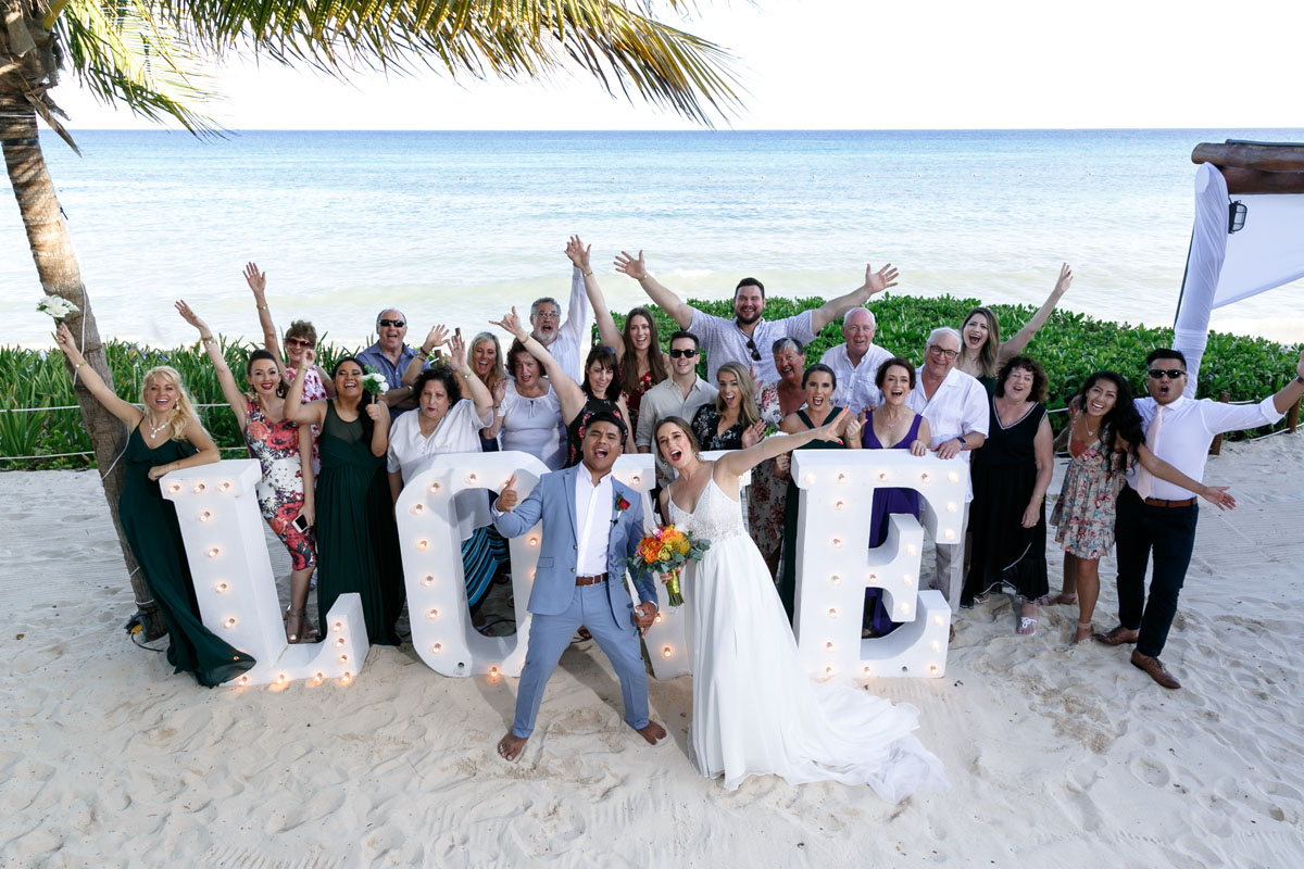 CheeringGuestsAndNewlywedsWaveToDrone